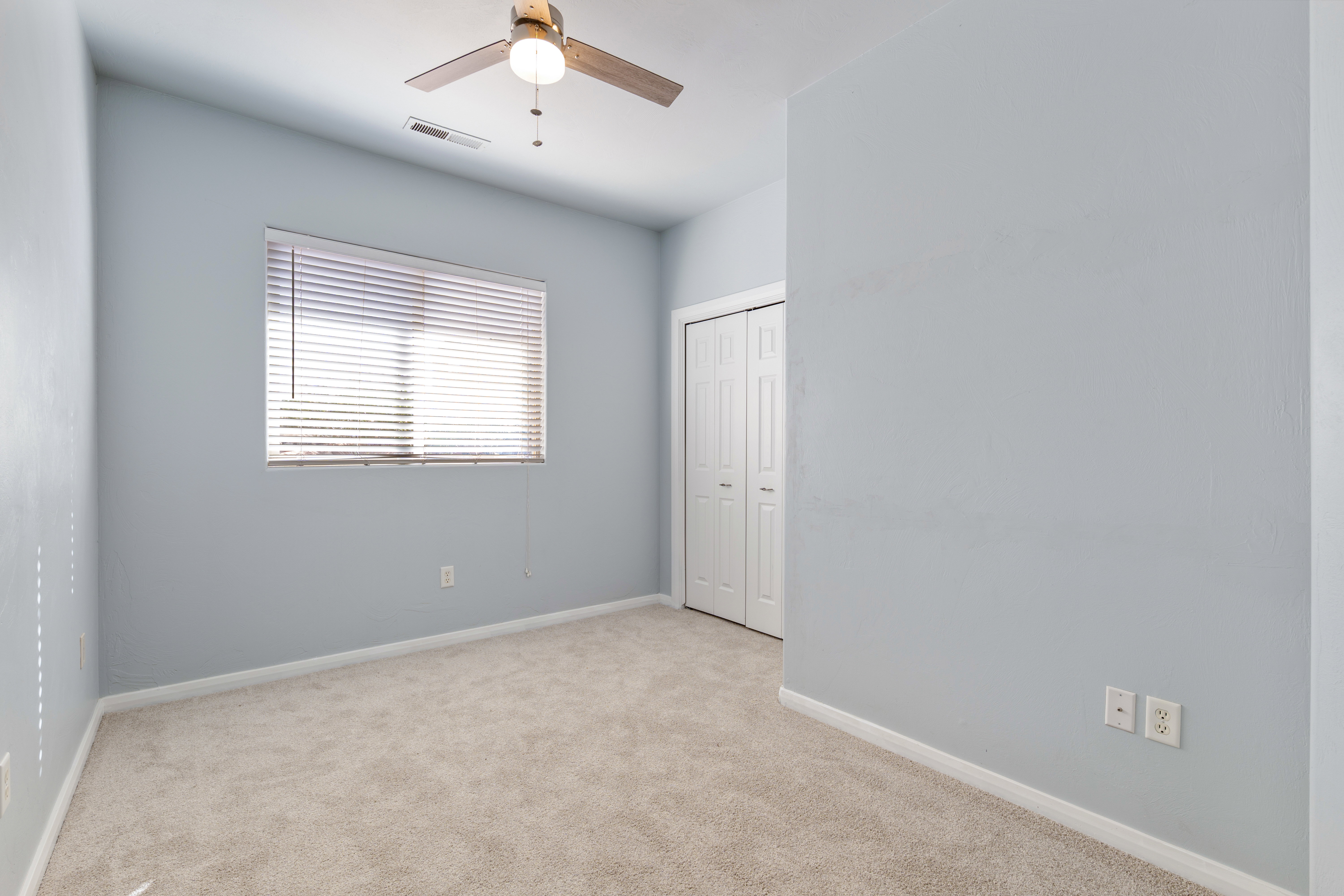 Unfurnished bedroom with carpet floors, a ceiling fan, and a closet