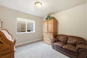 Sitting room with light carpet and baseboards