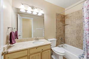 Bathroom with shower / bath combination with curtain and vanity