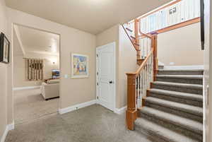 Stairs featuring carpet floors and baseboards