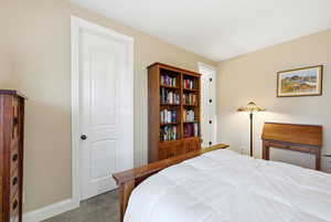 Carpeted bedroom featuring baseboards