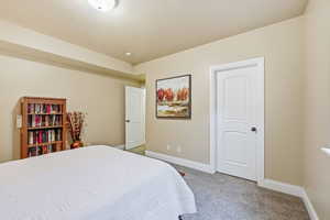 Bedroom with carpet flooring and baseboards