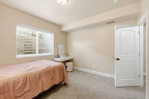Carpeted bedroom with baseboards