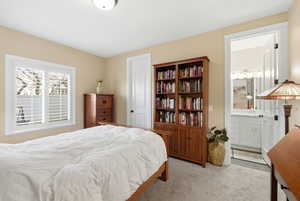 Bedroom featuring light carpet