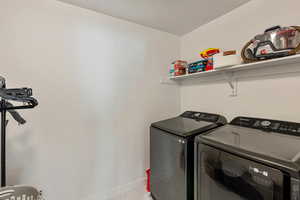 Laundry room with shelving, conveniently located next to bedrooms