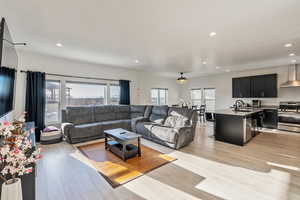 Living area with recessed lighting and laminate flooring