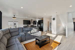 Open concept living with stairs to basement and half bath on main floor.