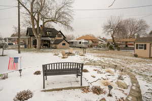 View of yard with a residential view, an outdoor structure, and a patio