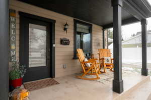Doorway to property with covered porch