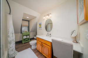 Bathroom with vanity, dark wood-style floors, and shower / bath combo