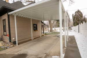View of vehicle parking with an attached carport