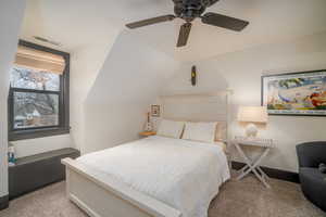Bedroom featuring lofted ceiling, light carpet, and a ceiling fan