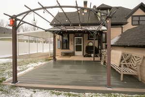 Wooden terrace featuring a sunroom