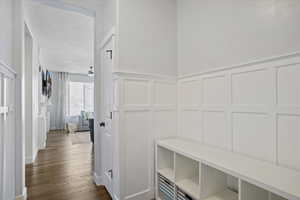 Mudroom with dark wood finished floors, ceiling fan, and a textured ceiling