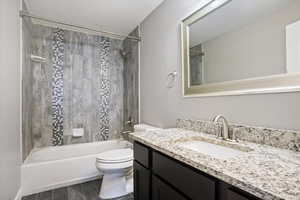 Bathroom with vanity, bathtub / shower combination, and wood tiled floors