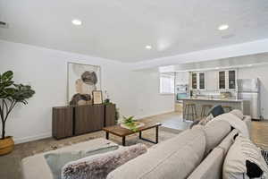 Living area featuring recessed lighting and light wood-style floors