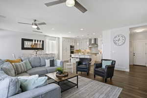 Living area with dark wood-style flooring and recessed lighting