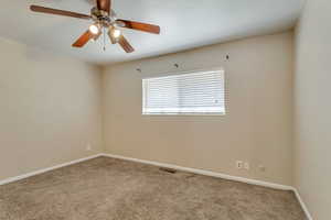 Spare room with carpet floors and a ceiling fan 890