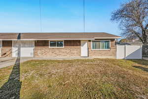 View of front of house featuring brick siding and roof with shingles
