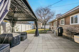 Fenced backyard featuring grilling area and a patio area 880