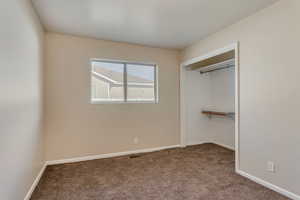 Unfurnished bedroom featuring a closet and carpet floors 890