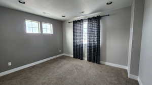 Spare room featuring light carpet and recessed lighting