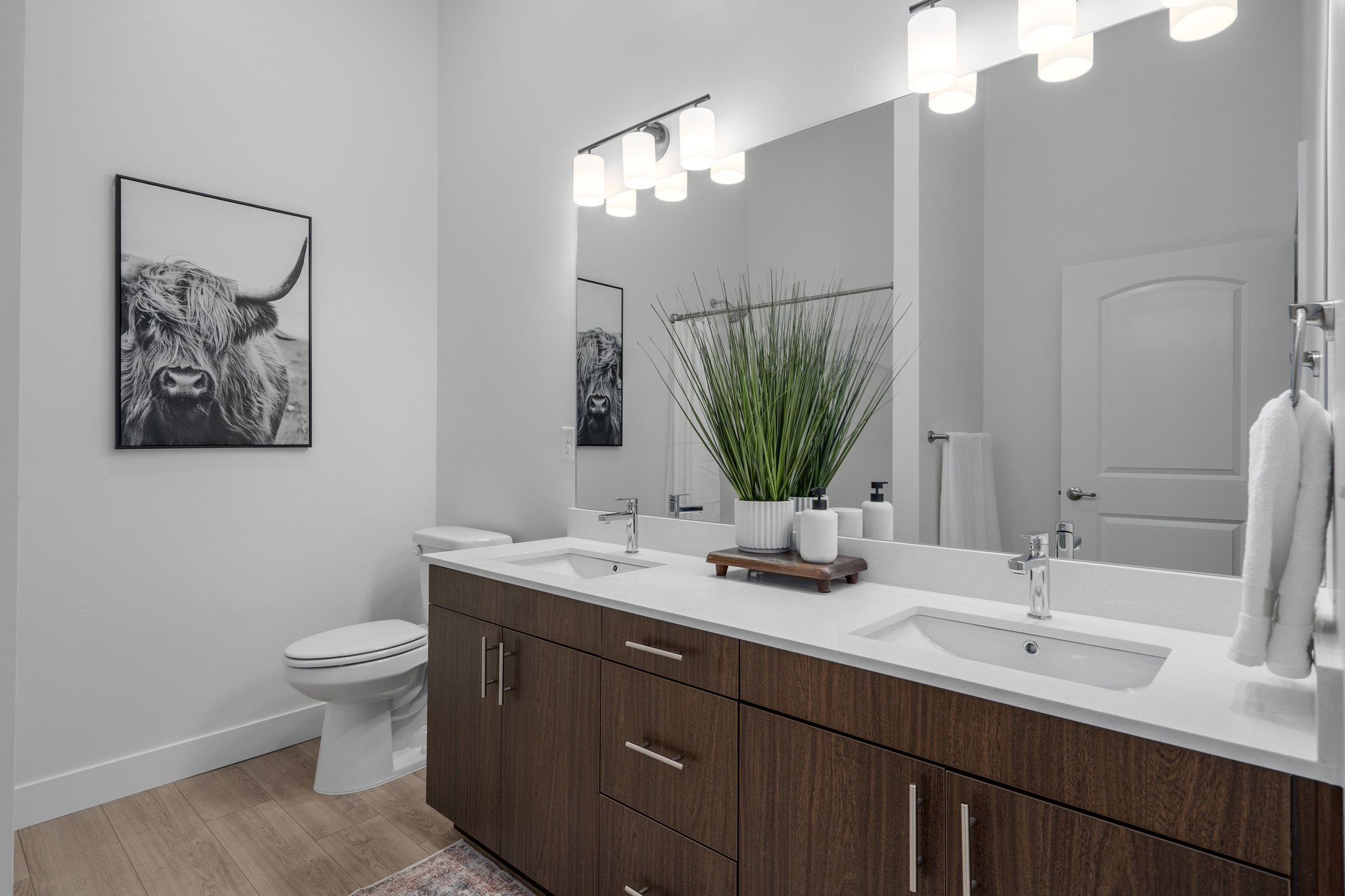 Primary bedroom en' suite with double vanity and walk in shower.