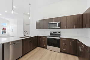 Quartz counters with tile backsplash and stainless steel appliances. *Fridge not included.
