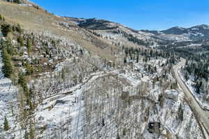 Snowy aerial view featuring a mountain view