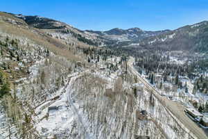 Snowy aerial view featuring a mountain view