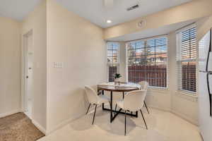 Dining room featuring light colored carpet and recessed lighting