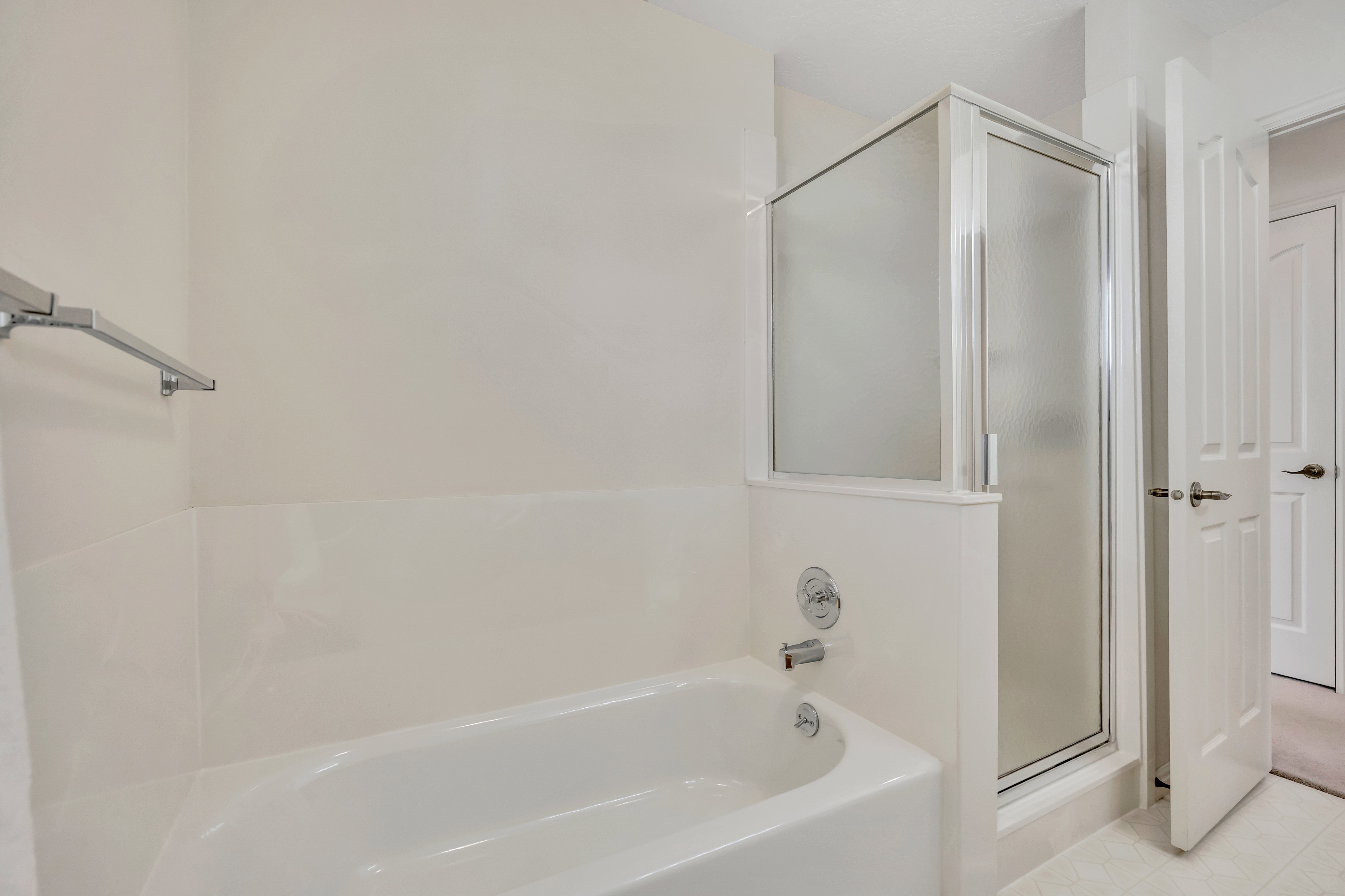 Bathroom featuring a shower stall and a garden tub