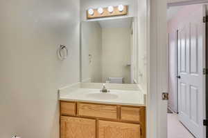 Bathroom with vanity and light flooring