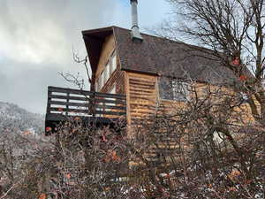 View of property exterior with roof with shingles