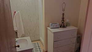 Full bathroom with vanity and a stall shower