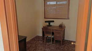 Office featuring dark carpet and baseboards