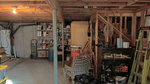 Unfinished below grade area featuring water heater