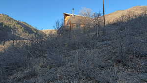 View of side of home with a mountain view