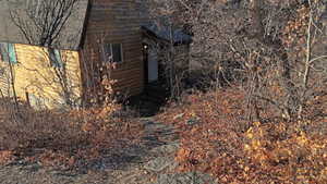 View of property exterior featuring faux log siding
