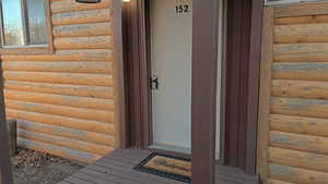 Entrance to property featuring faux log siding
