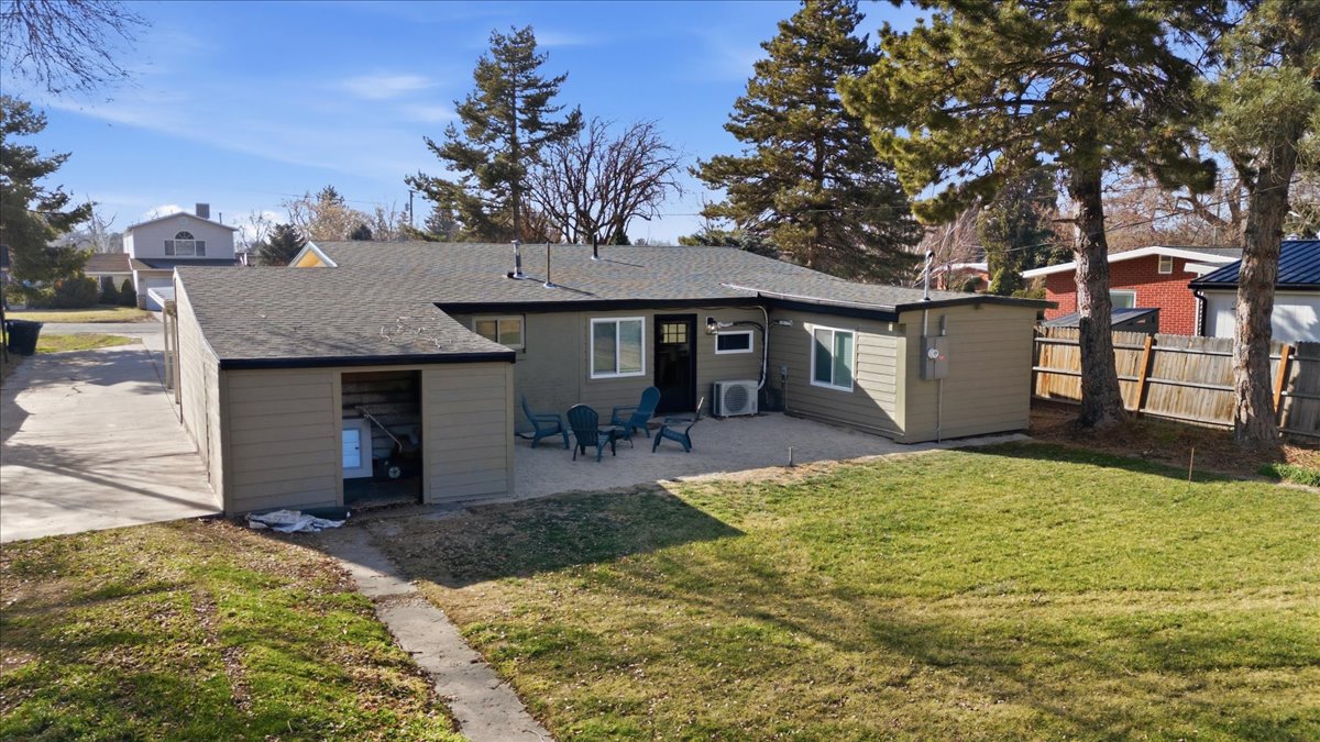 Rear view of property featuring a shingled roof