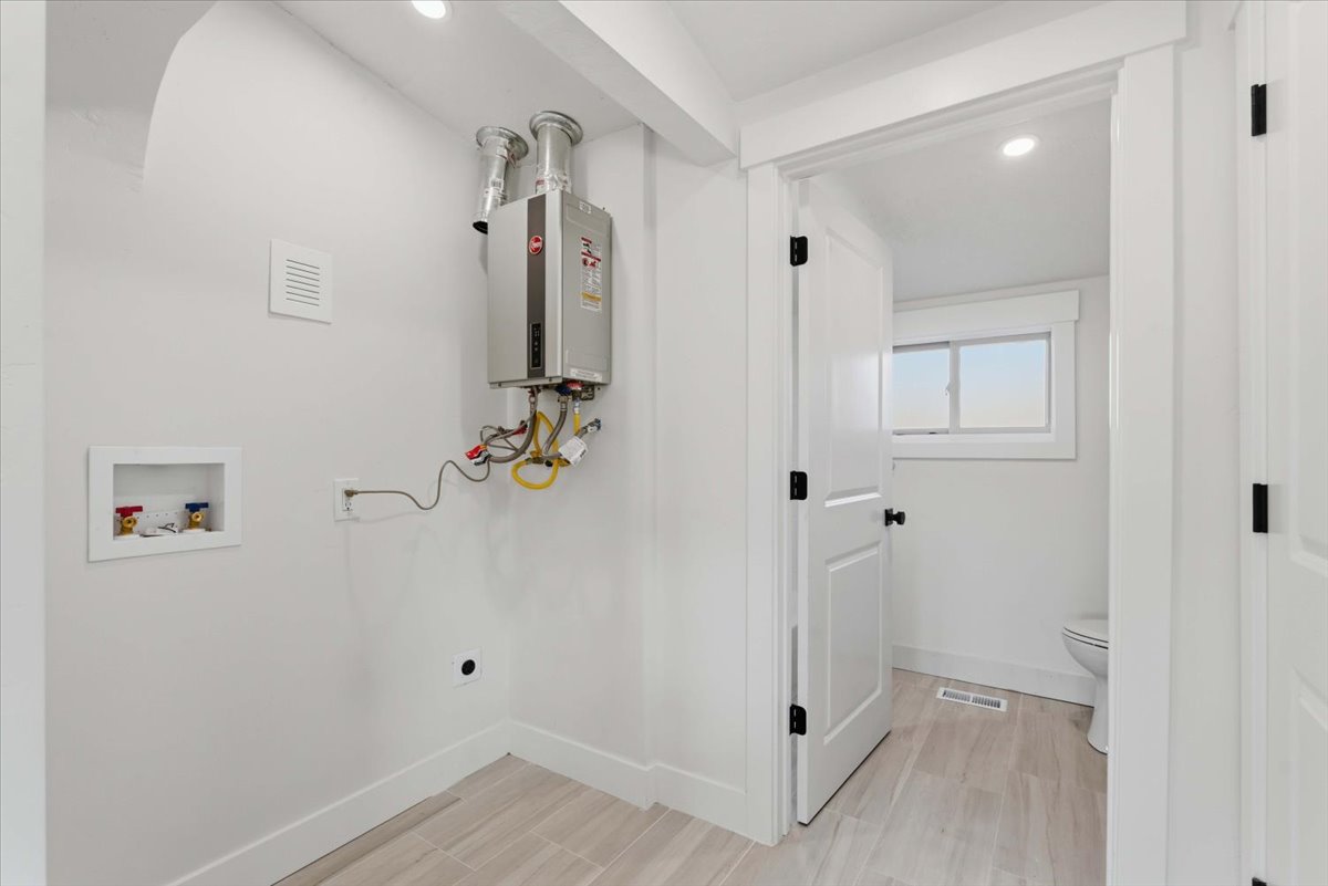 Laundry area with hookup for a washing machine, recessed lighting, wood finish floors, and electric dryer hookup