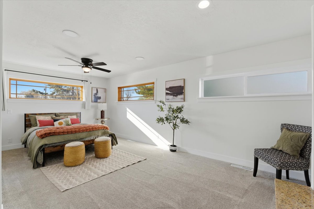 Bedroom with carpet floors and a ceiling fan