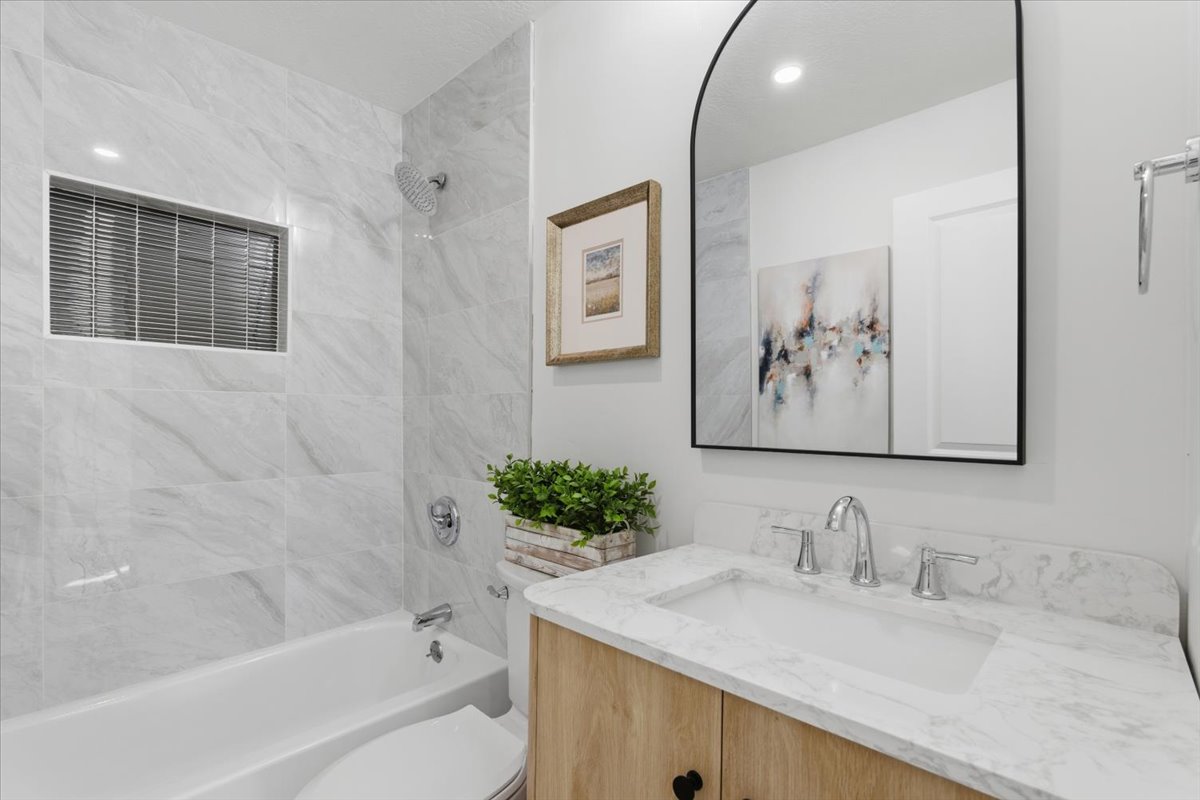 Bathroom with vanity and shower / bath combination