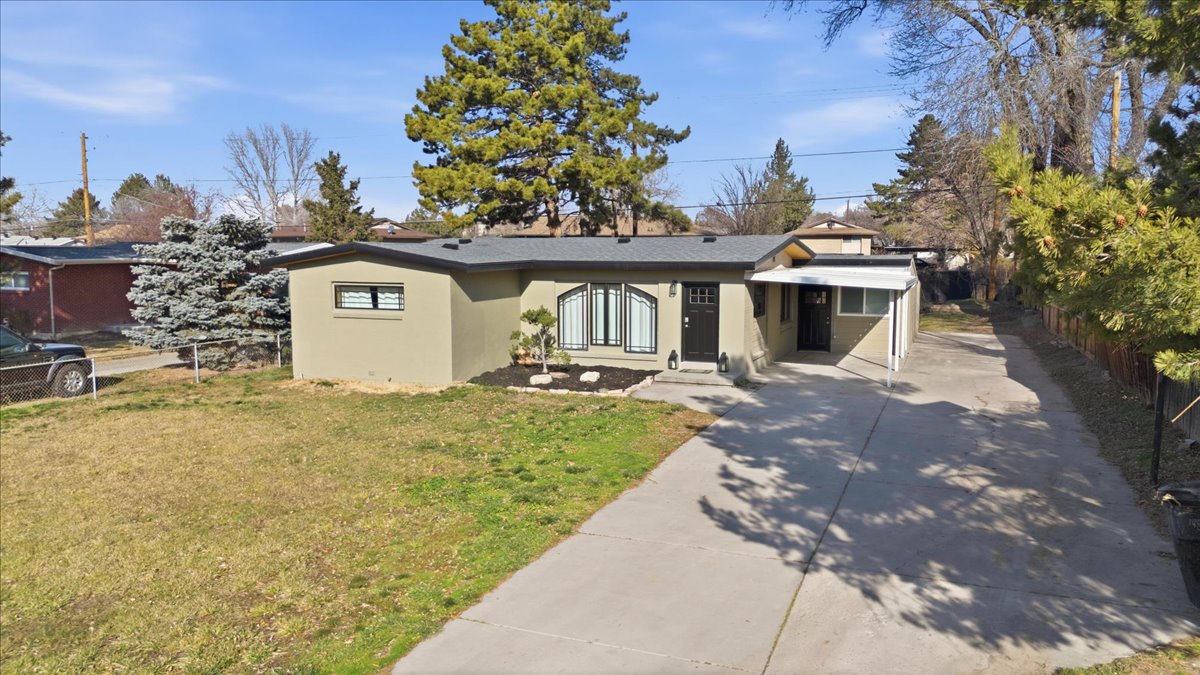 View of front of home with concrete driveway and stucco siding