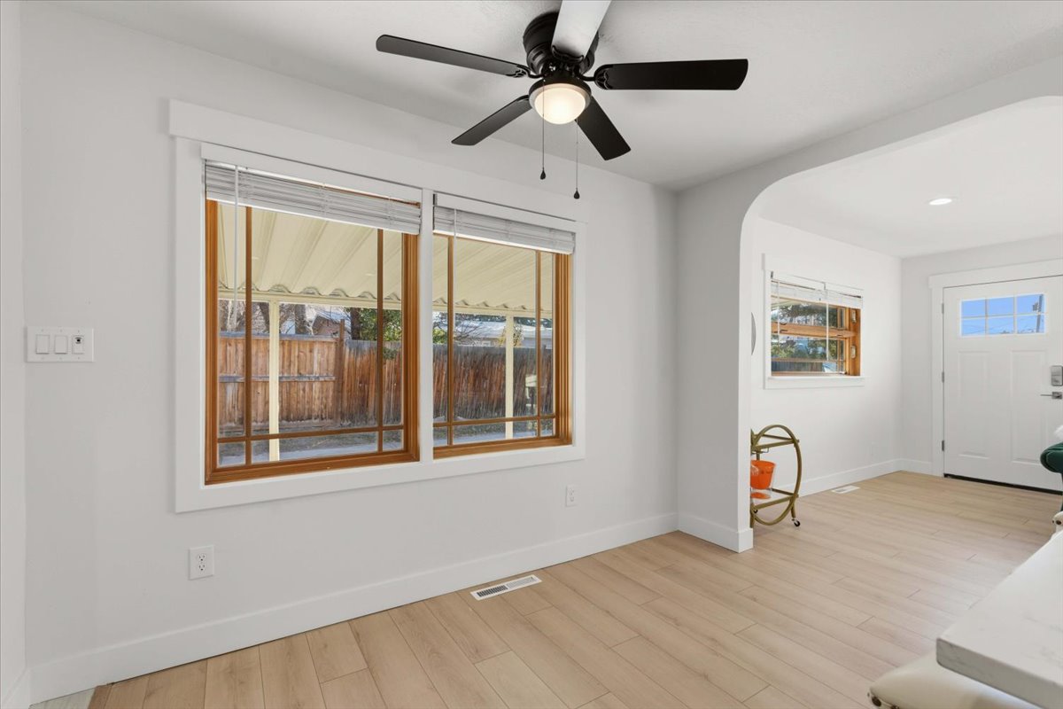 Entryway with light wood-style flooring, healthy amount of natural light, recessed lighting, arched walkways, and a ceiling fan