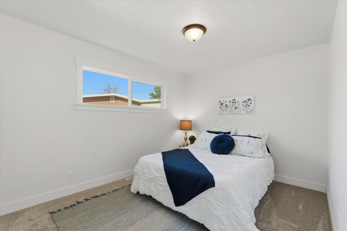 Bedroom with carpet flooring and baseboards