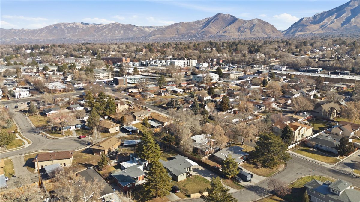 Aerial view of property's location with a mountain backdrop and nearby suburban area