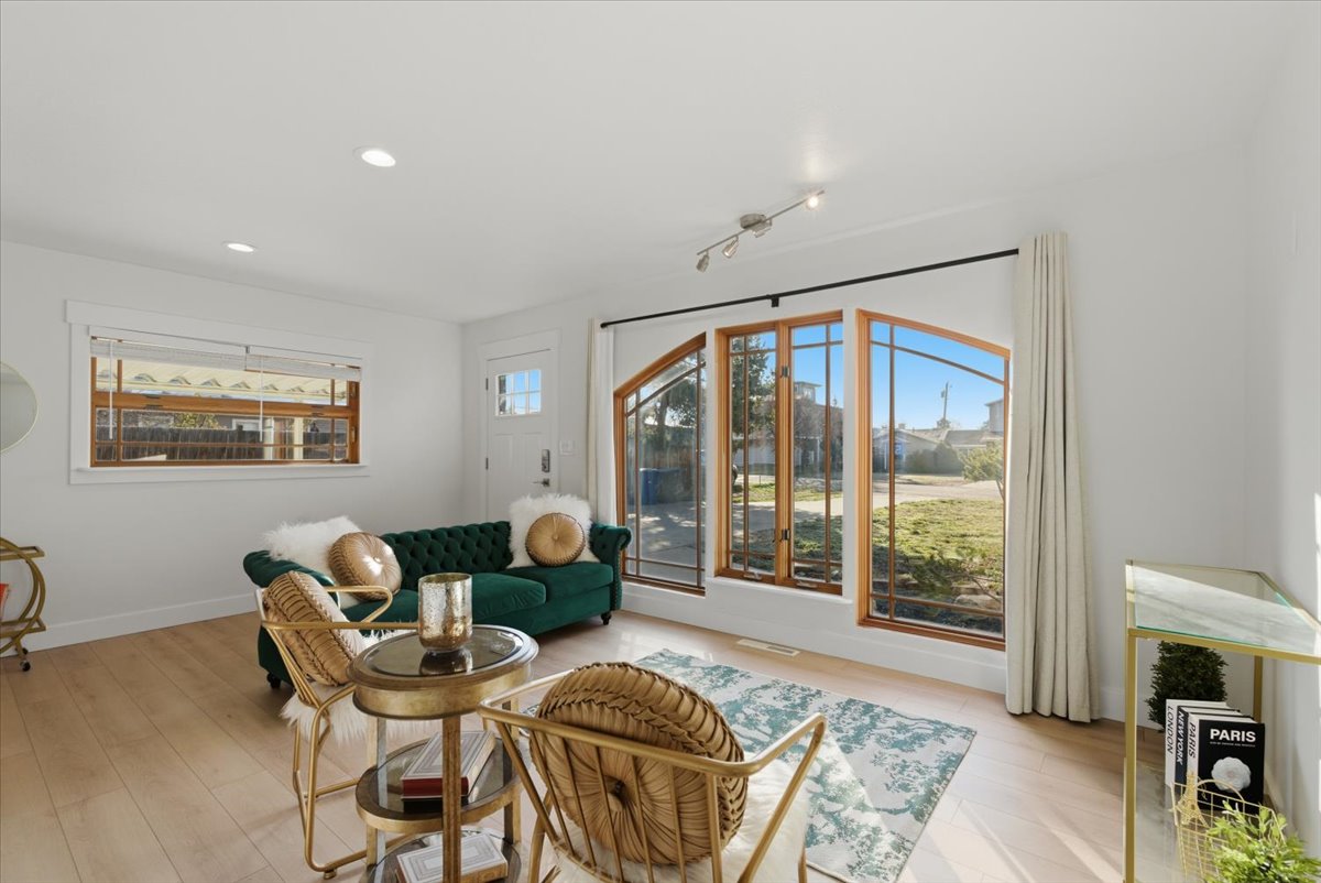 Living area with light wood-style flooring and recessed lighting
