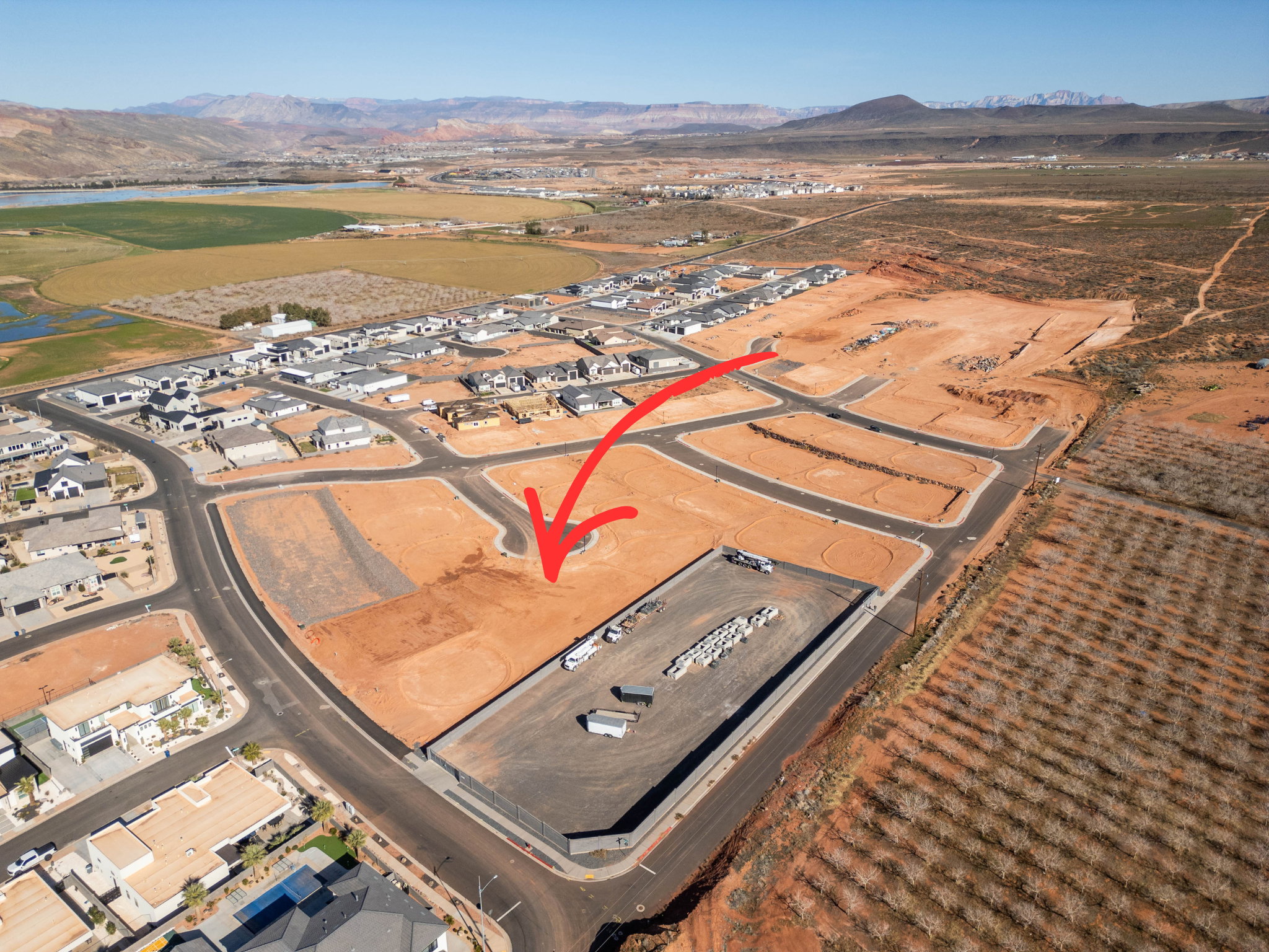 Aerial view of property and surrounding area with a water and mountain view and nearby suburban area